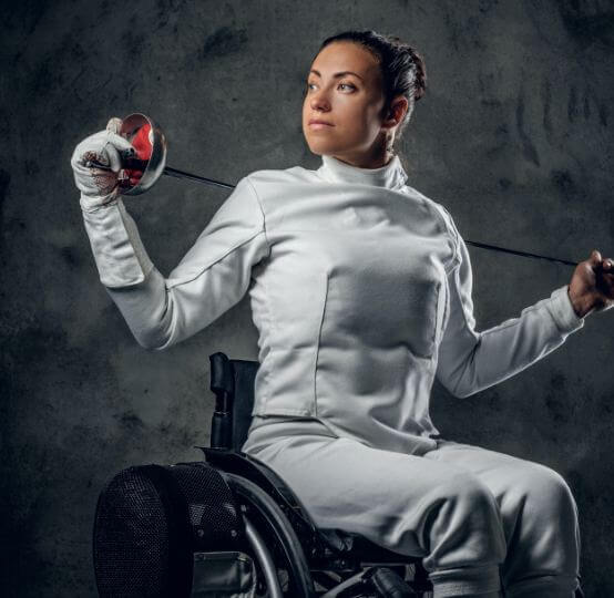 Woman in wheelchair in fencing outfit
