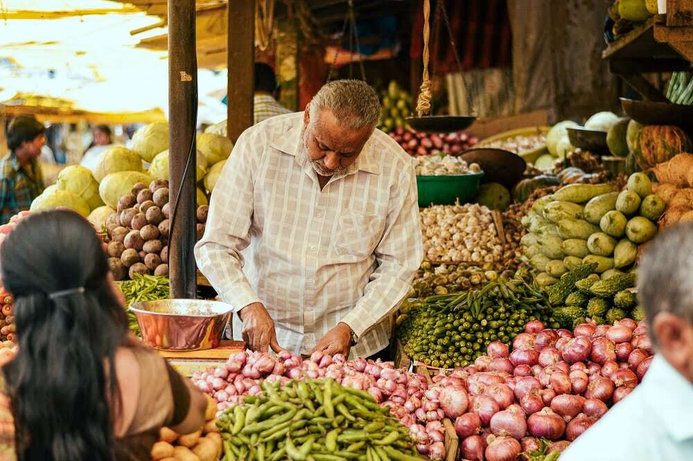 Man looking at vegetable in market