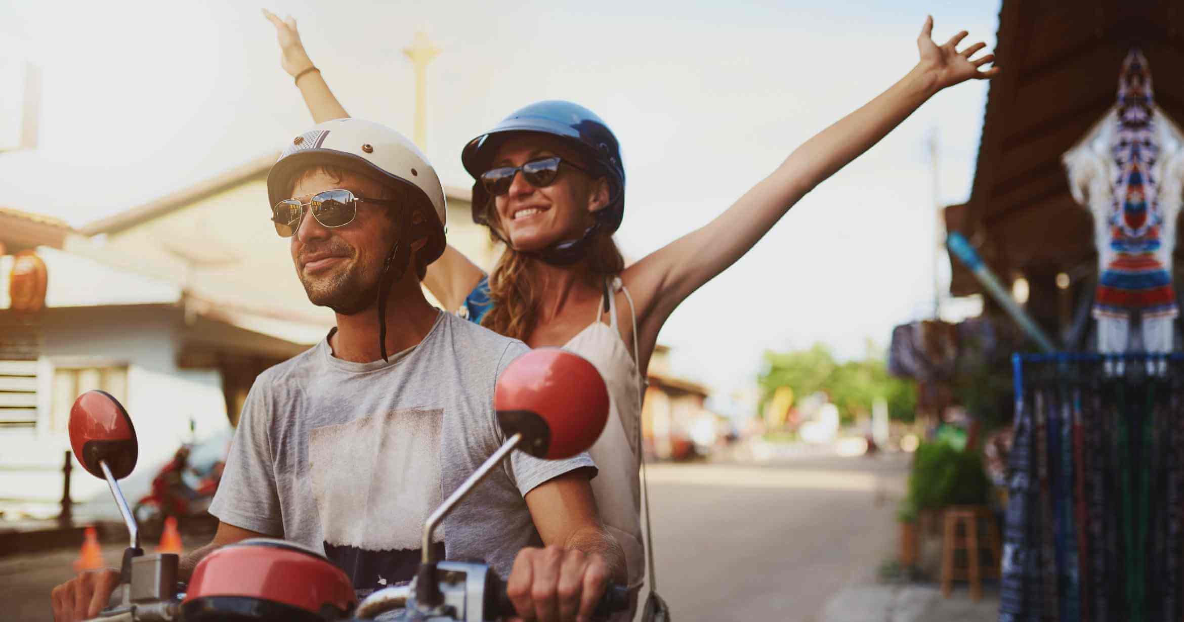 Couple on scooter wearing sunglasses