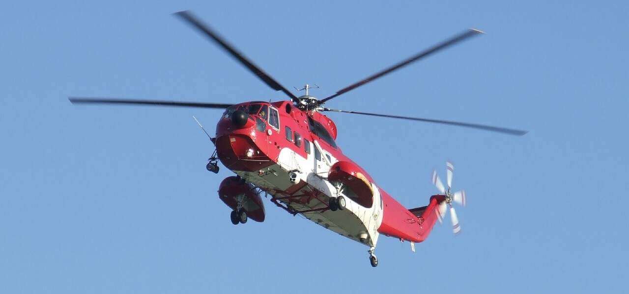 Red helicopter in flight